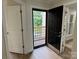 A well-lit entryway with hardwood floors and access to a balcony at 633 Portside Dr, Davidson, NC 28036