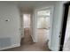 Hallway featuring a bathroom, bedroom, wood floors and light-colored walls at 633 Portside Dr, Davidson, NC 28036