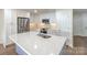 Bright kitchen with a large island, stainless steel appliances, white cabinets, and tile backsplash at 633 Portside Dr, Davidson, NC 28036