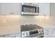 Modern kitchen featuring stainless steel appliances and white cabinetry for a sleek design at 633 Portside Dr, Davidson, NC 28036
