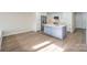 Open-concept kitchen with stainless steel appliances, white cabinets, gray island, and hardwood floors at 633 Portside Dr, Davidson, NC 28036