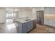 Open kitchen featuring a center island, stainless steel appliances, and seamless flow to the living area at 633 Portside Dr, Davidson, NC 28036