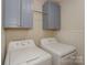 Laundry room with washer, dryer, and overhead cabinets at 633 Portside Dr, Davidson, NC 28036