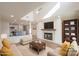 Open concept living room with a fireplace, television, hardwood floors, and kitchen at 633 Portside Dr, Davidson, NC 28036