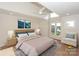 Staged main bedroom featuring a large bed, stylish decor, and ample natural light at 633 Portside Dr, Davidson, NC 28036