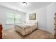 Comfortable bedroom with bright window, carpet floors and neutral walls at 7327 Snowbird Ct, Mint Hill, NC 28227