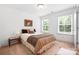 Cozy bedroom with two windows that provide natural light, carpet floors and neutral walls at 7327 Snowbird Ct, Mint Hill, NC 28227