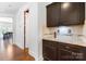 Butler's pantry features dark cabinetry, granite countertops, and a convenient wine storage area at 7327 Snowbird Ct, Mint Hill, NC 28227