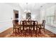 Elegant dining room with wainscoting, modern lighting, and seating for six around an oval table at 7327 Snowbird Ct, Mint Hill, NC 28227