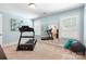 Bright exercise room with a treadmill, mirrors, and lots of natural light at 7327 Snowbird Ct, Mint Hill, NC 28227