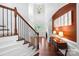 Bright foyer with high ceilings, hardwood floors, staircase, and elegant decor at 7327 Snowbird Ct, Mint Hill, NC 28227