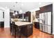 Gourmet kitchen featuring dark wood cabinets, stainless steel appliances, and granite countertops at 7327 Snowbird Ct, Mint Hill, NC 28227