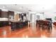 Open kitchen with dark wood cabinetry, granite countertops, and stainless steel appliances at 7327 Snowbird Ct, Mint Hill, NC 28227