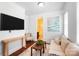 Cozy sitting room with a comfortable couch, modern decor, and a view to the bathroom at 7327 Snowbird Ct, Mint Hill, NC 28227