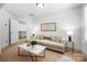 Cozy living room with a cream sofa, modern coffee table, and plenty of natural light at 7327 Snowbird Ct, Mint Hill, NC 28227