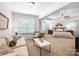 Spacious main bedroom with a sitting area, large windows, and modern furnishings at 7327 Snowbird Ct, Mint Hill, NC 28227