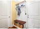 Functional mudroom with coat rack, bench with storage, and easy access to the garage at 7327 Snowbird Ct, Mint Hill, NC 28227