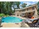 Stunning backyard pool with patio seating and an outdoor kitchen, perfect for entertaining guests at 7327 Snowbird Ct, Mint Hill, NC 28227