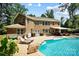 Backyard with a large pool, outdoor kitchen, patio and lounge seating perfect for entertaining at 7327 Snowbird Ct, Mint Hill, NC 28227