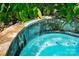 Close-up of the rock wall waterfall feature in the pool, adding a touch of elegance and tranquility at 7327 Snowbird Ct, Mint Hill, NC 28227