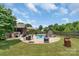 Spacious backyard with pool, patio, and lush green lawn, perfect for outdoor activities and relaxation at 773 Hathcock Glen Dr, Oakboro, NC 28129