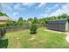 Large grassy backyard featuring a wooden fence and storage shed at 773 Hathcock Glen Dr, Oakboro, NC 28129