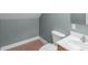 A functional half bathroom with a tiled floor, toilet, and vanity sink at 773 Hathcock Glen Dr, Oakboro, NC 28129