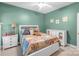Cozy bedroom with a queen bed, white dressers, and decorative accents at 773 Hathcock Glen Dr, Oakboro, NC 28129