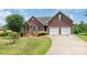 Traditional brick home with well-kept landscaping, a two-car garage, and a welcoming facade at 773 Hathcock Glen Dr, Oakboro, NC 28129