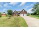 Attractive brick home with a manicured front lawn, mature landscaping, and a two-car garage at 773 Hathcock Glen Dr, Oakboro, NC 28129