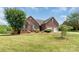 Beautiful brick home with a well-manicured lawn, mature trees, and an attached two-car garage at 773 Hathcock Glen Dr, Oakboro, NC 28129