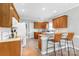Functional kitchen featuring wood cabinets, breakfast bar, and modern appliances at 773 Hathcock Glen Dr, Oakboro, NC 28129