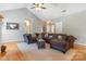 Inviting living room with vaulted ceilings, a comfortable couch, hardwood floors, and great natural lighting at 773 Hathcock Glen Dr, Oakboro, NC 28129