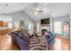 Spacious living room with vaulted ceiling, hardwood floors, a fireplace, and ample natural light creates an inviting atmosphere at 773 Hathcock Glen Dr, Oakboro, NC 28129