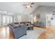Bright living room featuring hardwood floors, a cozy couch, and abundant natural light, perfect for gatherings at 773 Hathcock Glen Dr, Oakboro, NC 28129