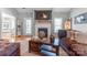 Cozy living room features a fireplace, a mantel with decor, and hardwood floors, perfect for relaxing evenings at 773 Hathcock Glen Dr, Oakboro, NC 28129