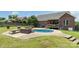 Gorgeous backyard pool area complete with fireplace and lounging, set in a well maintained lawn at 773 Hathcock Glen Dr, Oakboro, NC 28129