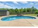 The pool area features a storage shed, a stone fireplace, and a wooded fence line at 773 Hathcock Glen Dr, Oakboro, NC 28129