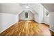 Large attic space with wood flooring and a window providing natural light at 8701 Holly Creek Ct, Charlotte, NC 28216