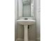 Powder room featuring a pedestal sink with a mirror at 8701 Holly Creek Ct, Charlotte, NC 28216