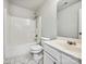 Bright bathroom featuring a shower-tub combo with white tile and a single sink vanity with modern fixtures at 8701 Holly Creek Ct, Charlotte, NC 28216