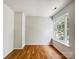 Bedroom featuring hardwood floors, neutral walls, and a large window offering ample natural light at 8701 Holly Creek Ct, Charlotte, NC 28216