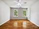 Empty bedroom with hardwood flooring, two windows providing natural light at 8701 Holly Creek Ct, Charlotte, NC 28216