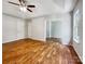 Large bedroom featuring hardwood floors, ceiling fan, neutral walls and a bonus room at 8701 Holly Creek Ct, Charlotte, NC 28216