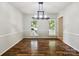 Dining room featuring hardwood floors, wainscoting, and a stylish chandelier at 8701 Holly Creek Ct, Charlotte, NC 28216