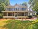Charming two-story home with a screened-in front porch and well-maintained landscaping at 8701 Holly Creek Ct, Charlotte, NC 28216