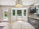 Kitchen nook featuring light-filled windows, tiled floors, and modern light fixture at 8701 Holly Creek Ct, Charlotte, NC 28216