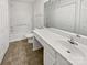 A bright bathroom features a pristine white vanity, a large mirror, and a shower-tub combo for a clean and functional space at 9121 Charminster Ct, Charlotte, NC 28269