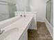 Bathroom featuring a large mirror, vanity with sink, and enclosed shower, all showcasing a modern design at 9121 Charminster Ct, Charlotte, NC 28269