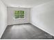 Cozy bedroom featuring soft carpet, natural light from a window, and freshly painted walls at 9121 Charminster Ct, Charlotte, NC 28269